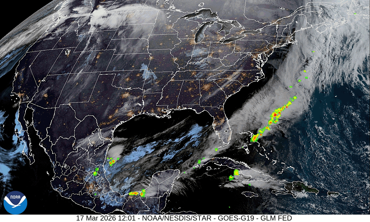 A cloudy satellite view of America is shown as the night-day divide sweeps across the continent. Bright green and yellow indicators clustered around the east coast indicate lightening bursts.