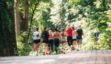 Front view. Group of runners are together outdoors.