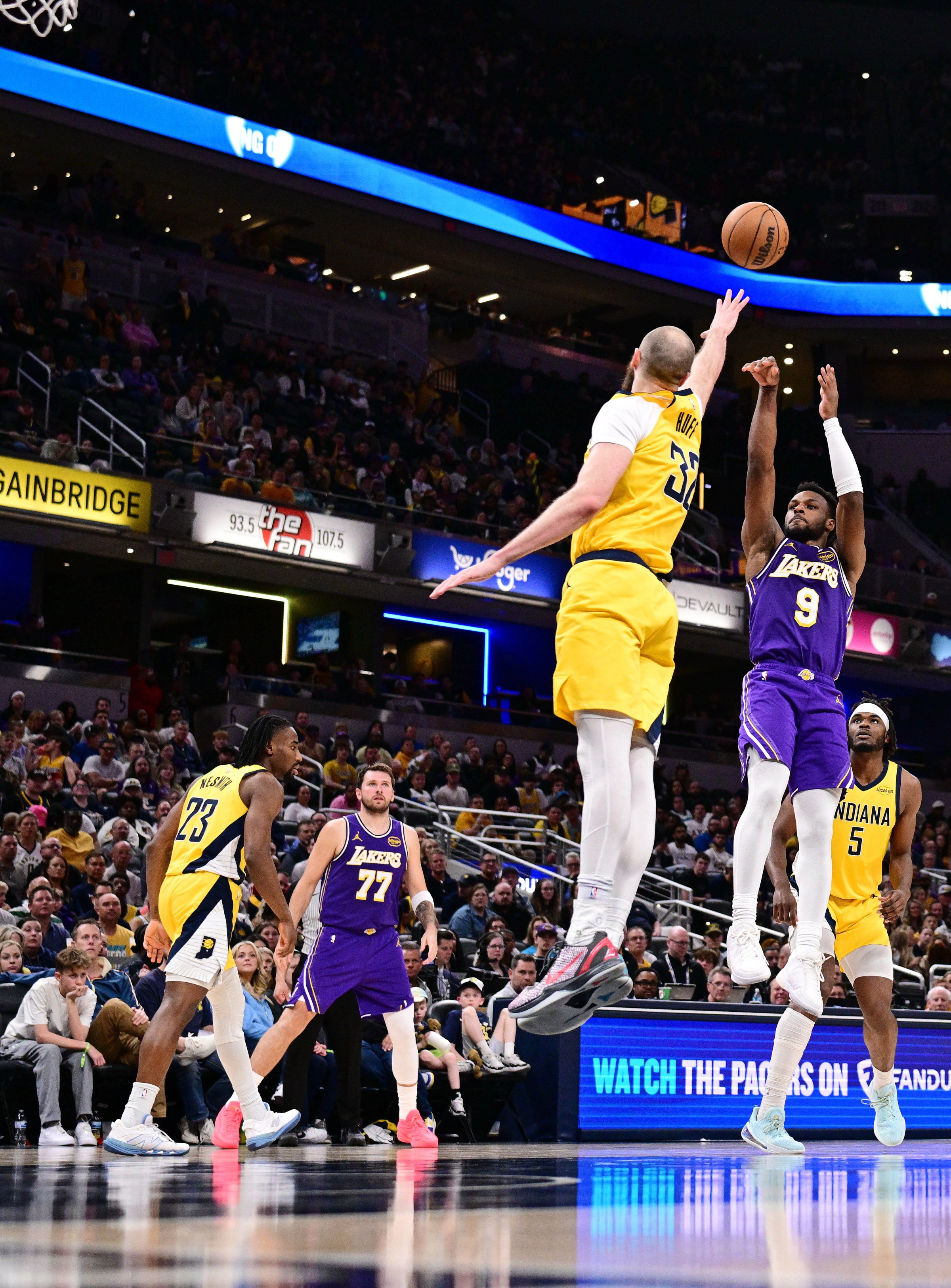 Mar 25, 2026; Indianapolis, Indiana, USA; Los Angeles Lakers guard Bronny James (9) shoots the ball over Indiana Pacers center Jay Huff (32) during the second half at Gainbridge Fieldhouse. Mandatory Credit: Marc Lebryk-Imagn Images