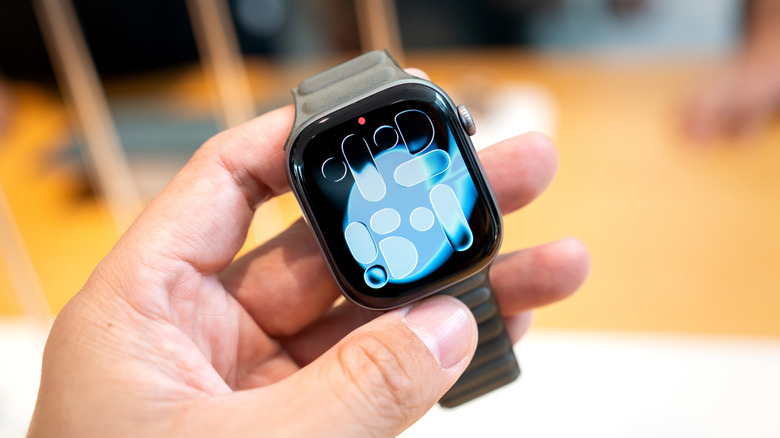 A person holding the Apple Watch Series 11 in their hand