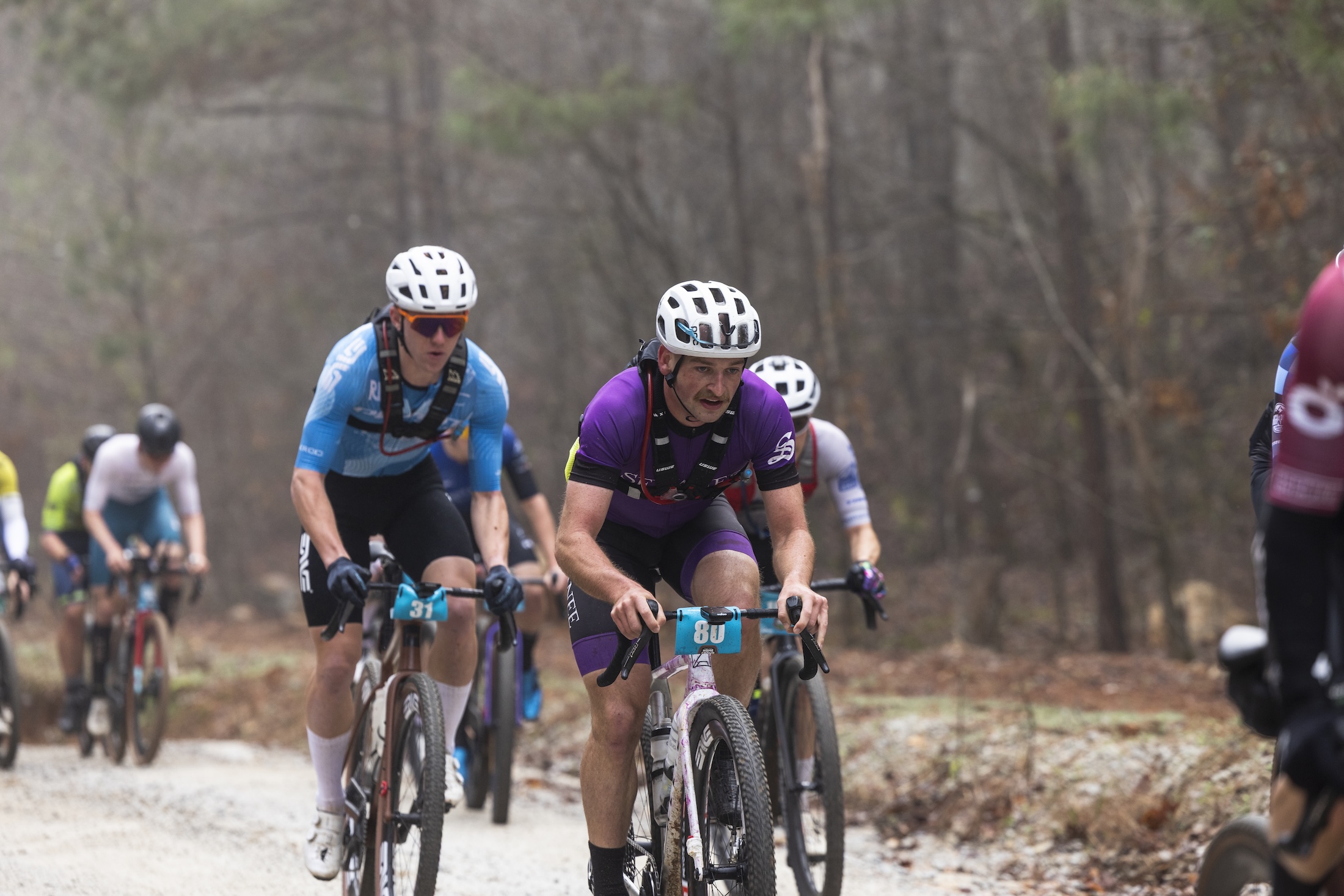 Elite men's winner Owen Clark of Pivot Cycles-OTE (left) rides in the pack before making the six-rider breakaway at Homegrown Gravel