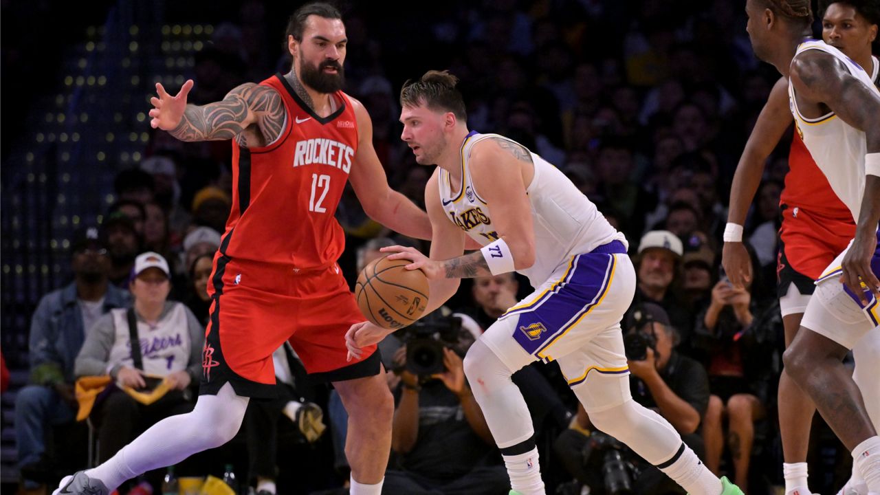 Houston Rockets center Steven Adams (12) guards Los Angeles Lakers guard Luka Doncic during the first half of an NBA basketball game on Thursday in LA. (AP Photo/Jayne Kamin-Oncea)