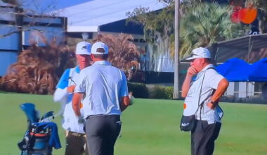 Larson (right) looking at Scheffler's club