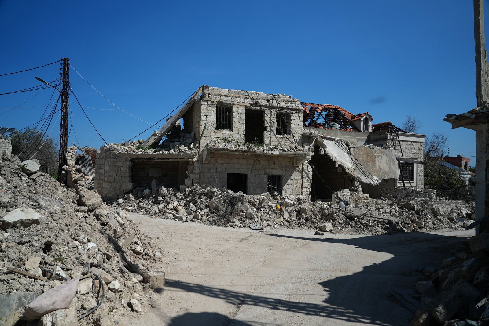 a house destroyed with a lot of rubble around it