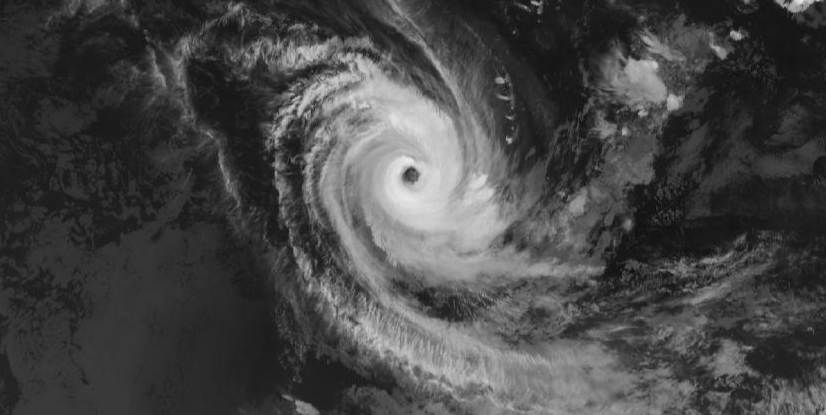 A satellite image of a large cyclone with a defined eye and swirling clouds.