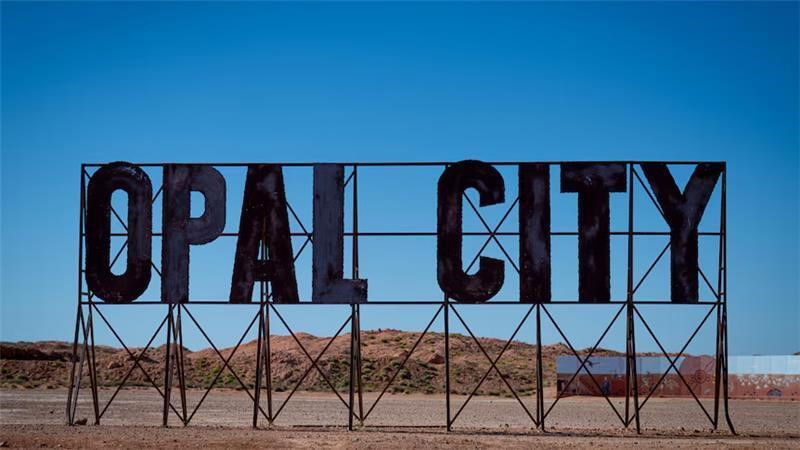 A sign that says 'Opal City'