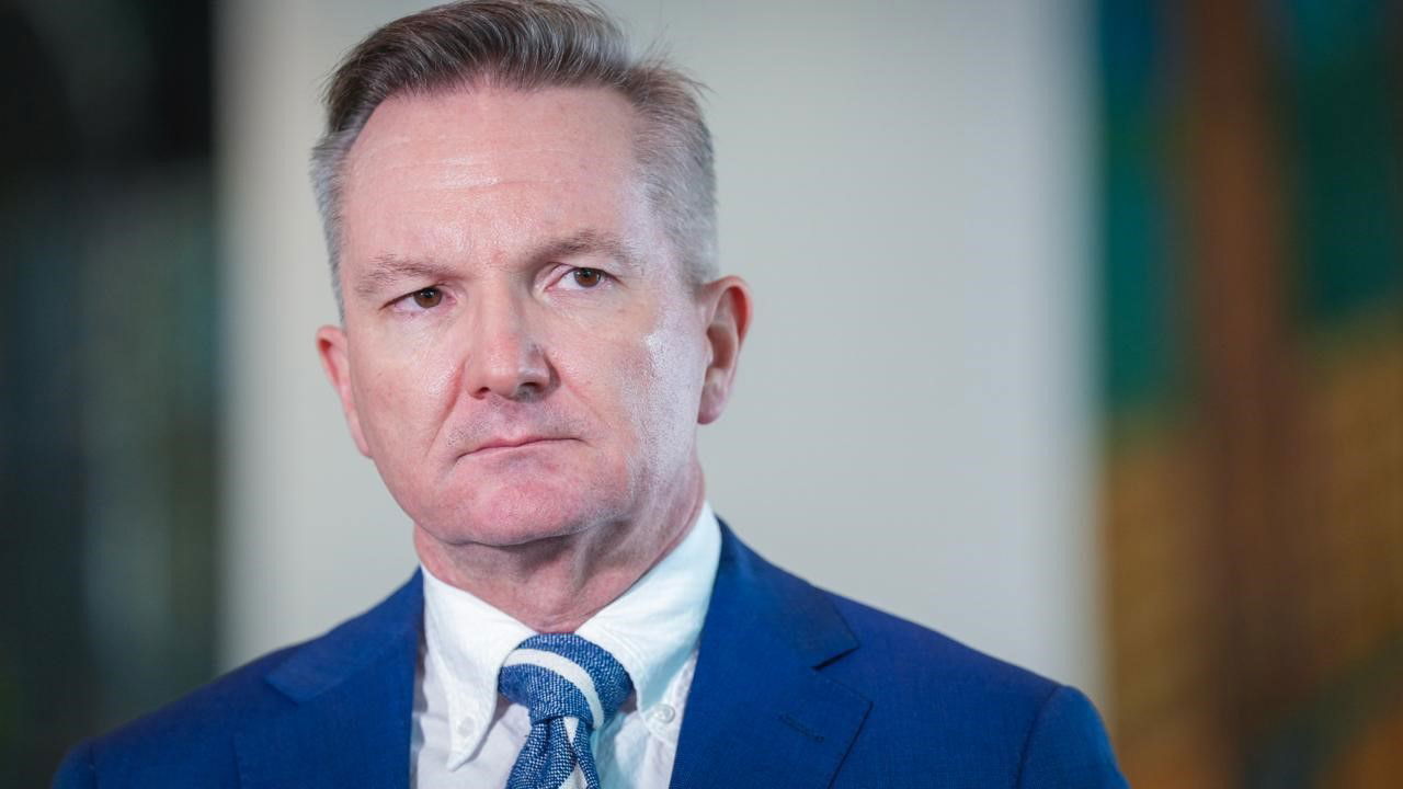 A close up of Chris Bowen looking serious