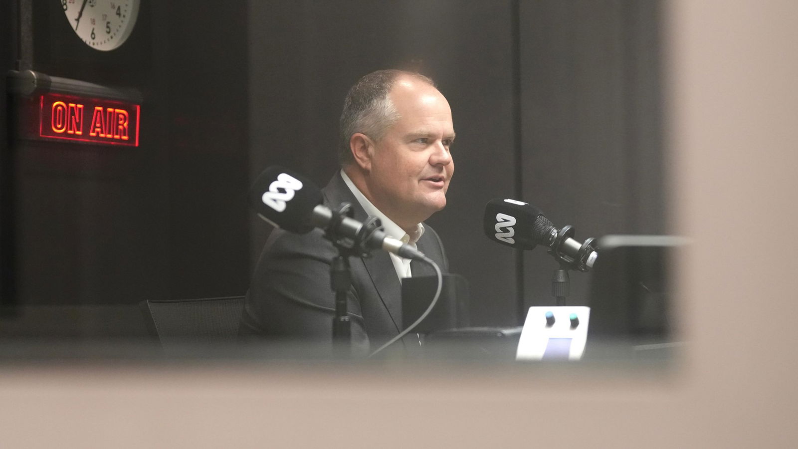 Ted O'Brien in the ABC's radio studio being interviewed for AM. 
