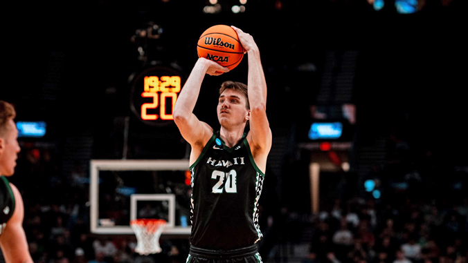 person shooting a basketball