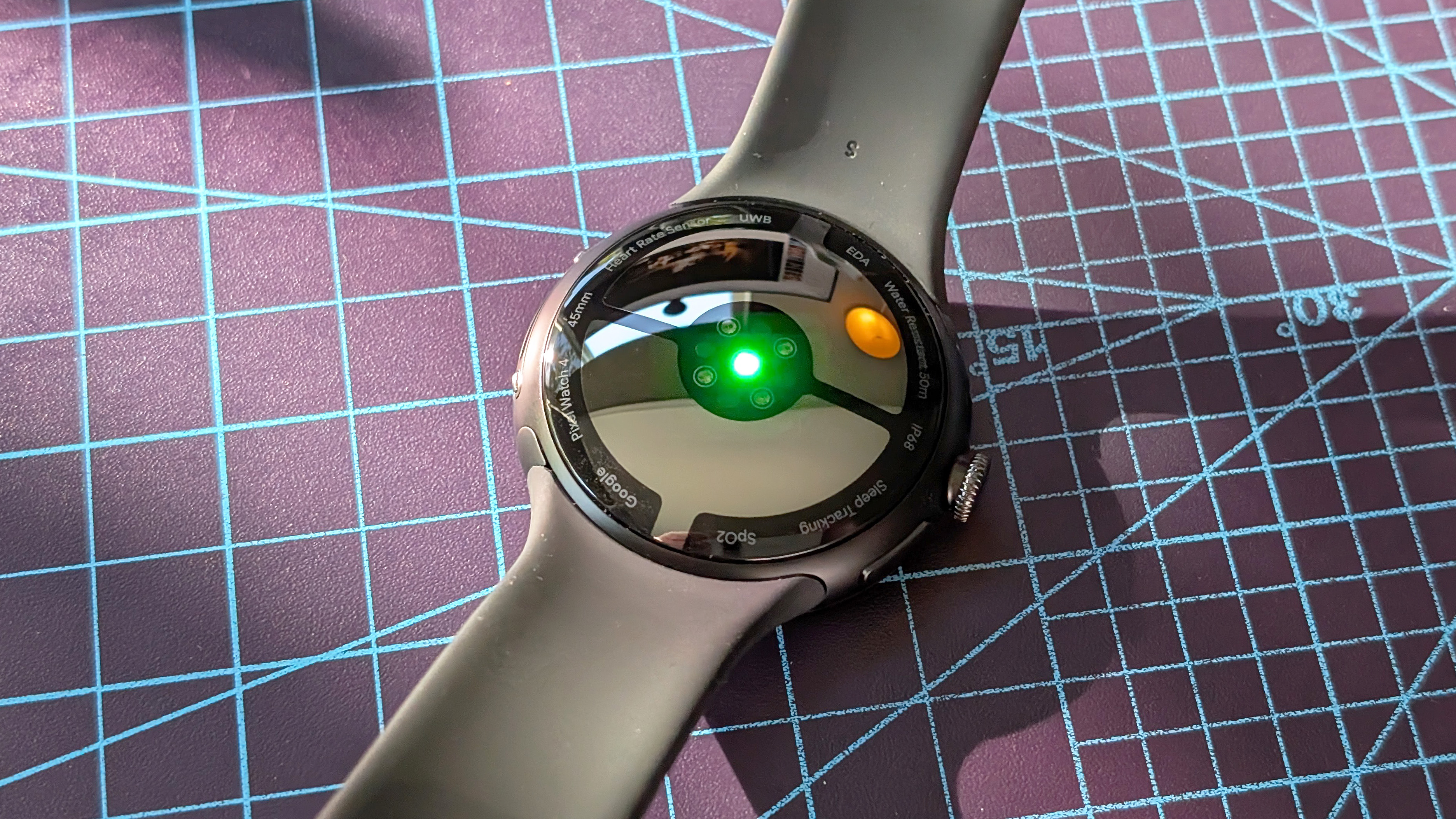 Close-up of the Google Pixel Watch 4 in black on a black strap