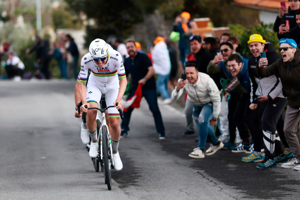Pogačar going for it on the Cipressa with fans cheering on from the roadside