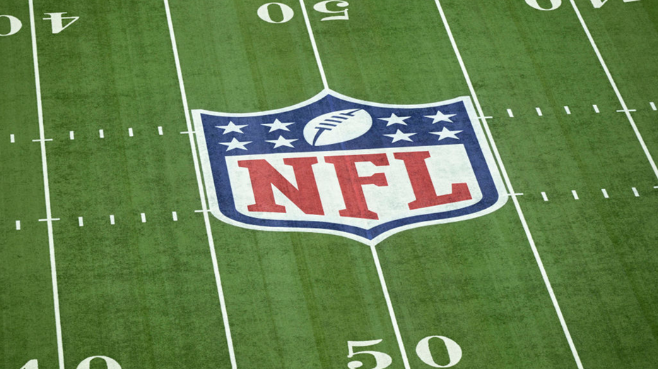 A view of the NFL Logo displayed on the field