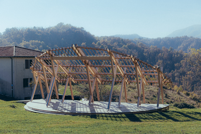 palcosole by grriz raises a half sun of timber above a historic park to gather community and light 2