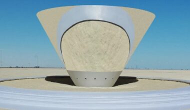 playful interactive cone installation reflects viewers sand art