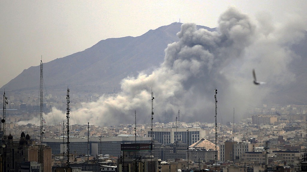 Smoke rises from buildings in Tehran, Iran after an airstrike.