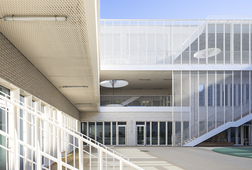 stepped white brick facade wraps school group in france by brenac & gonzalez & associés - 2