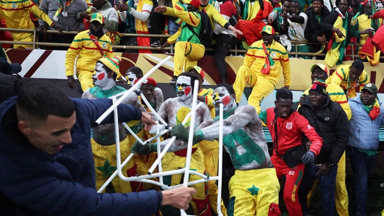 Senegal fans clash with security as fans invade the pitch