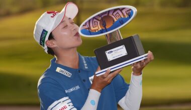 Hyo Joo Kim, of South Korea, poses for photographs as she kisses the winner's trophy after winning the LPGA Ford Championship golf tournament, Sunday, March 29, 2026, in Chandler, Ariz. (AP Photo/Ross D. Franklin)