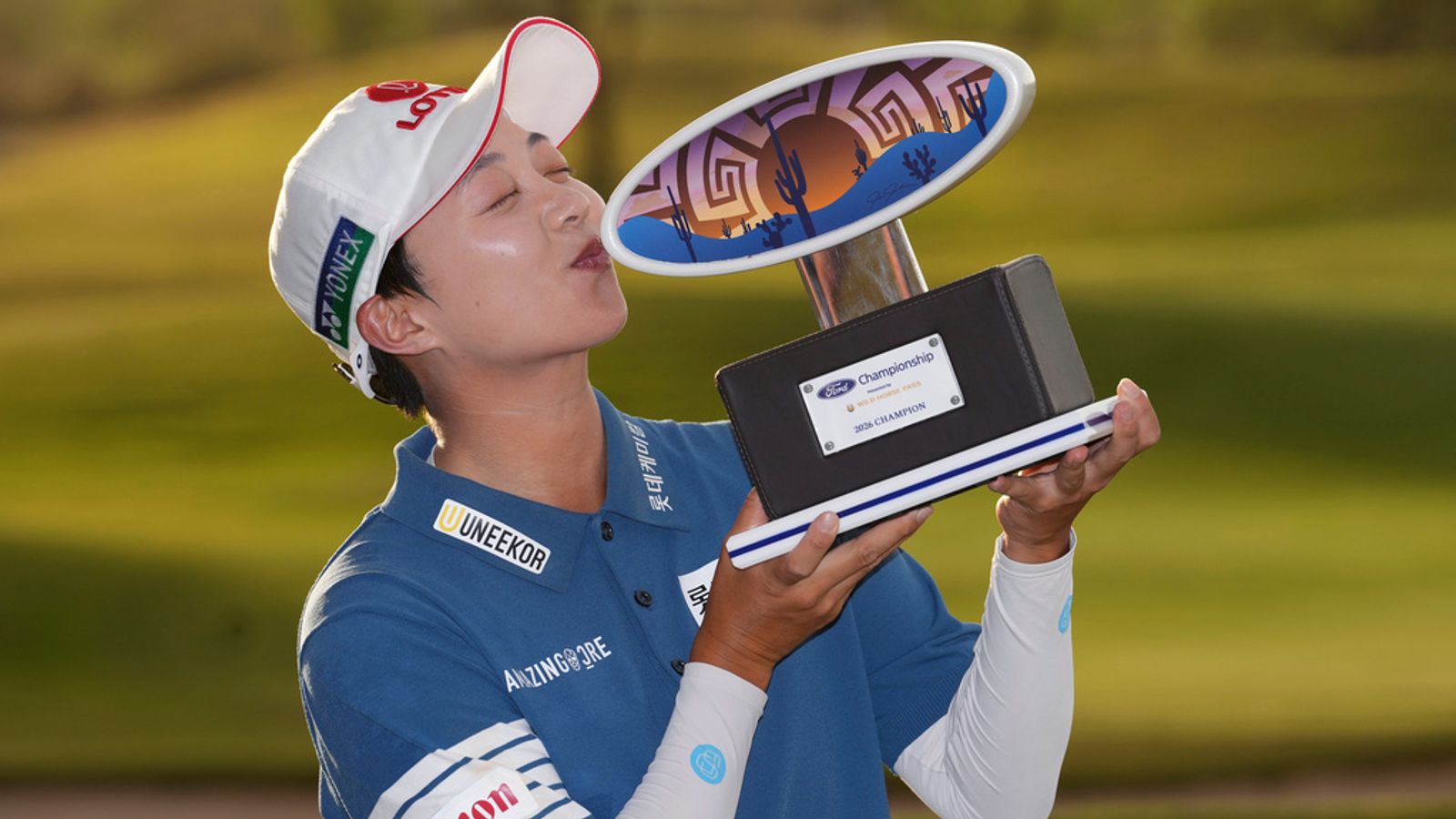 Hyo Joo Kim, of South Korea, poses for photographs as she kisses the winner's trophy after winning the LPGA Ford Championship golf tournament, Sunday, March 29, 2026, in Chandler, Ariz. (AP Photo/Ross D. Franklin)