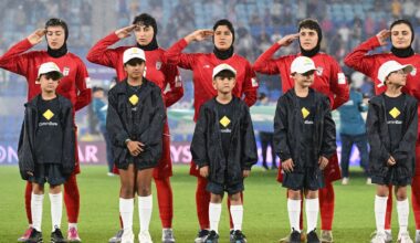 Iran players react during their national anthem ahead of the Women's Asian Cup soccer match between Iran and the Philippines