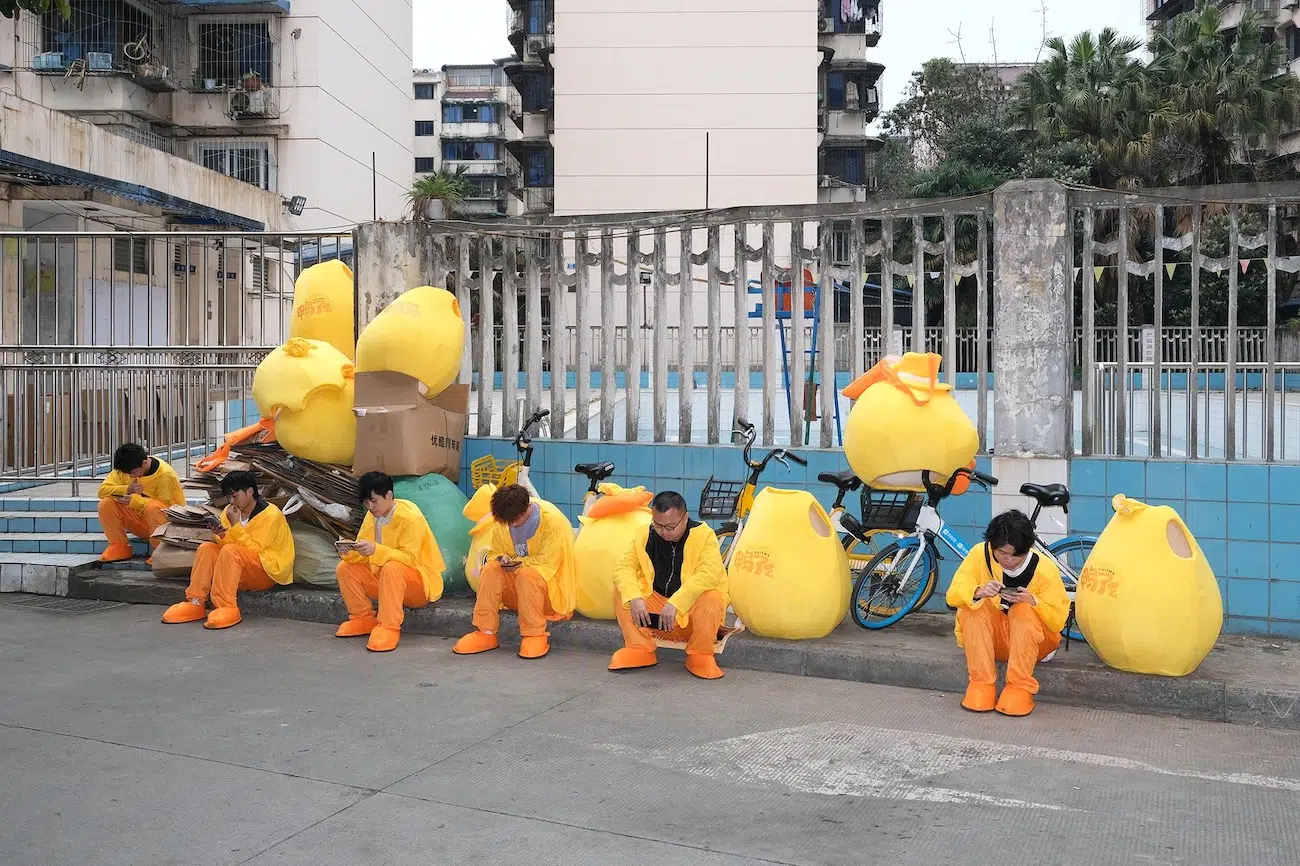 Event performers taking a break while half in their chicken costumes