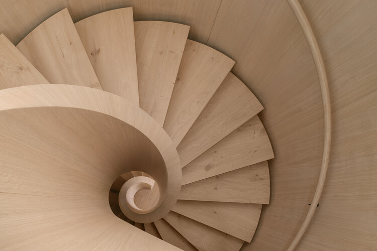 Transforming a Concrete Shell into a Wooden Interior Shaped by the Sea - Image 1 of 15