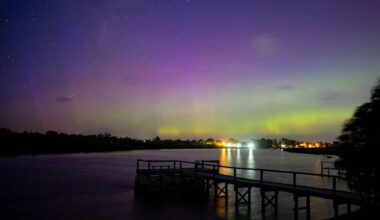 Sky lit up with green and purple aurora lights.