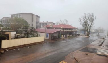A rain-battered town in Western Australia is lashed by high winds and heavy rain from Tropical Cyclone Narelle. The town street depicted is deserted and covered in debris.