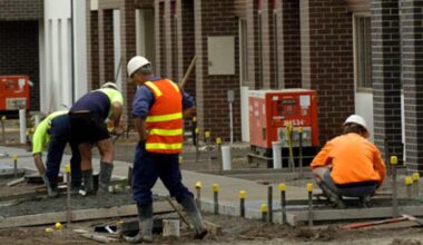 Construction workers in hi-vis working on a job site.