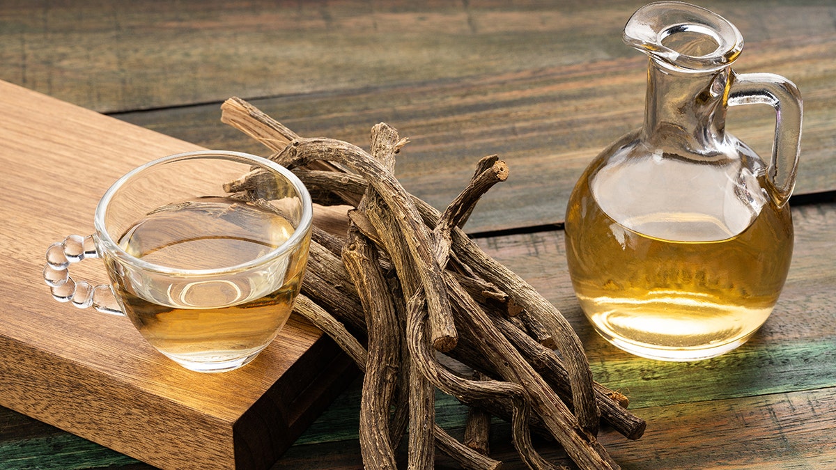 valerian roots in between a tea cup and oil glassware