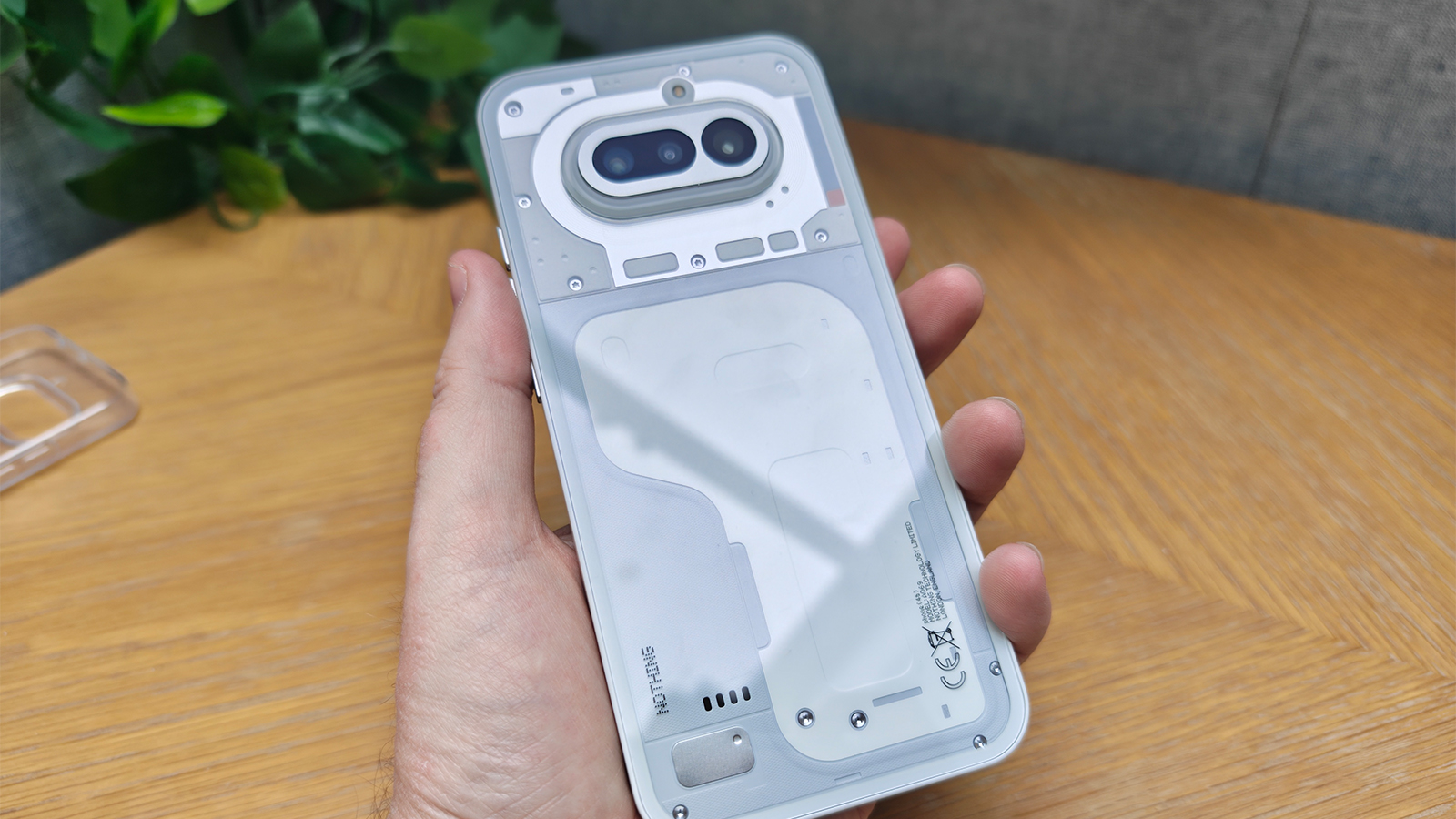 A white smartphone on a wooden desk