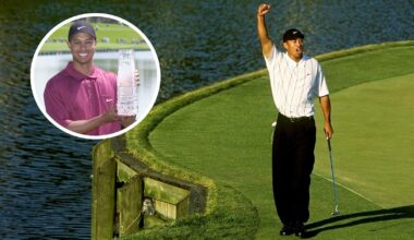 Tiger Woods fist pumps and holds The Players Championship trophy
