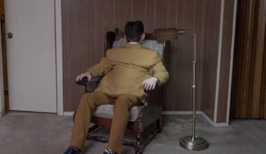 a surreal portrait by photographer Ben Zankn depicting a figure sitting at a seat, its head and back turned the opposite way