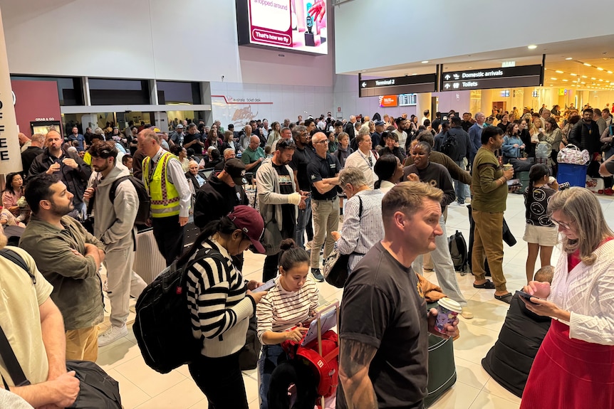 A big crowd of people inside an airport