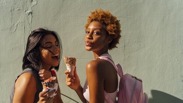 Two homen happily eating ice cream