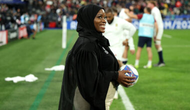A photograph of a smiling Zainab Alema, waiting pitchside to present the match ball to the referee, ahead of the England v South Africa men