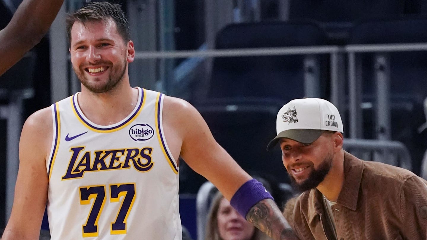 Feb 28, 2026; San Francisco, California, USA;  Injured Golden State Warriors guard Stephen Curry (30) laughs with Los Angeles Lakers forward/guard Luka Doncic (77) in the third period at Chase Center. Mandatory Credit: David Gonzales-Imagn Images