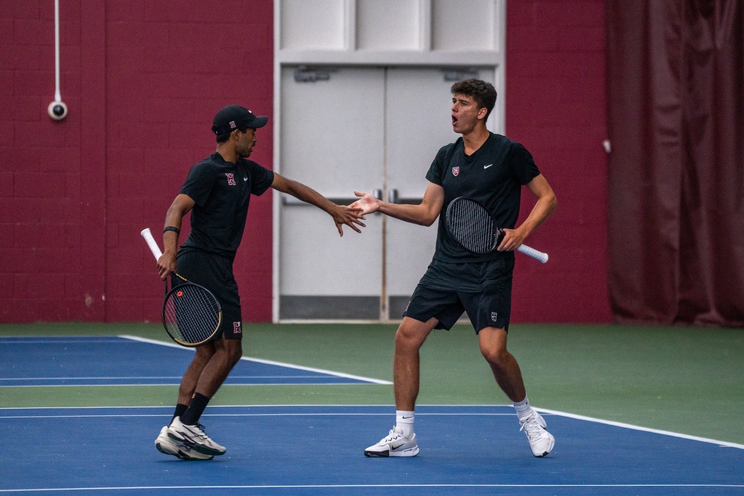 Doubles partners junior Rohan Murali and freshman Kolos Kincses cheer each other on. 