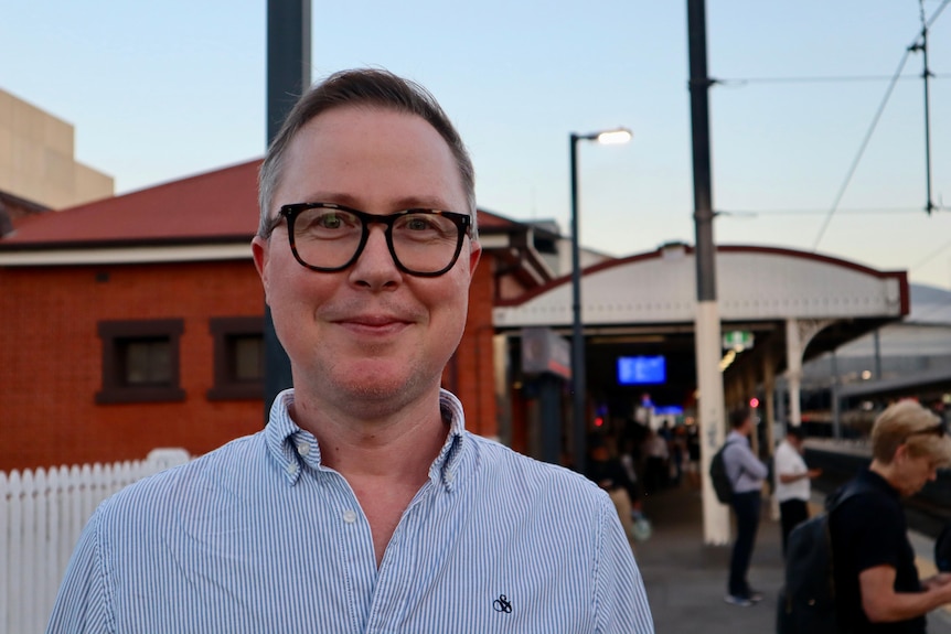 A man standing at the train station