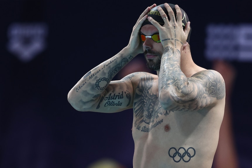 Kyle Chalmers holds his head