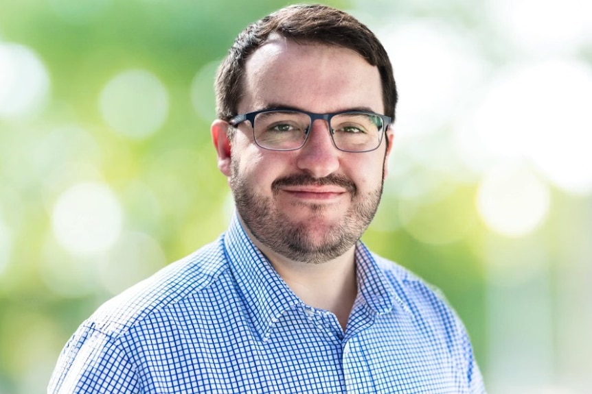 A headshot of a man smiling at the camera. 