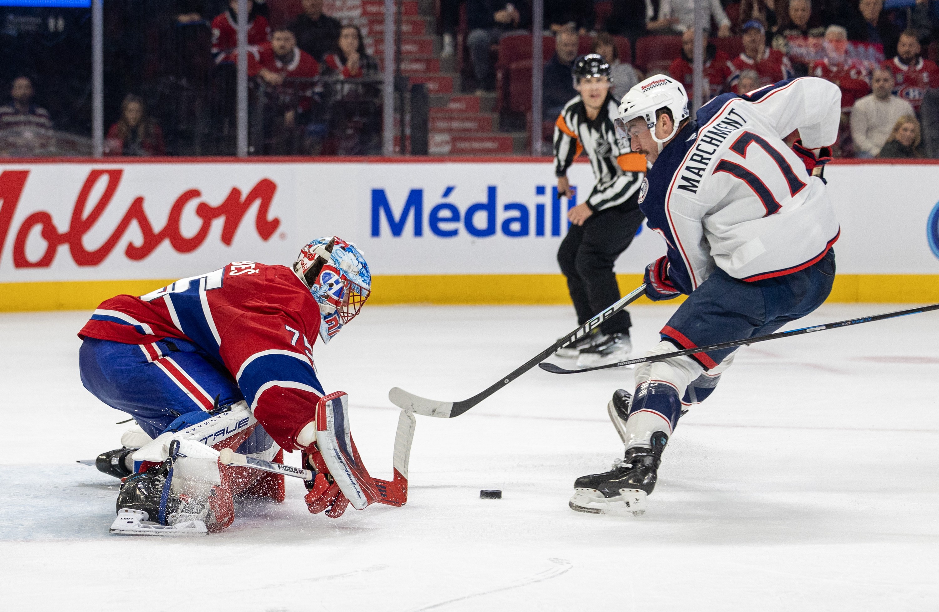 Canadiens' Jakub Dobes, stopping a breakaway attempt by Columbus Blue Jackets' Mason Marchment in Montreal on March 26, is riding a four-game winning streak and has won five of his last six starts.