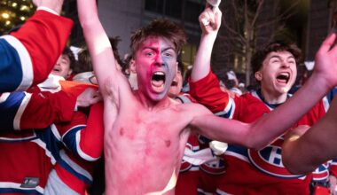 Shirtless Canadiens fan Lyam Péloquin celebrates the team's overtime win with hundreds of other Habs jersey-clad fans surrounding him Friday night outside the Bell Centre.