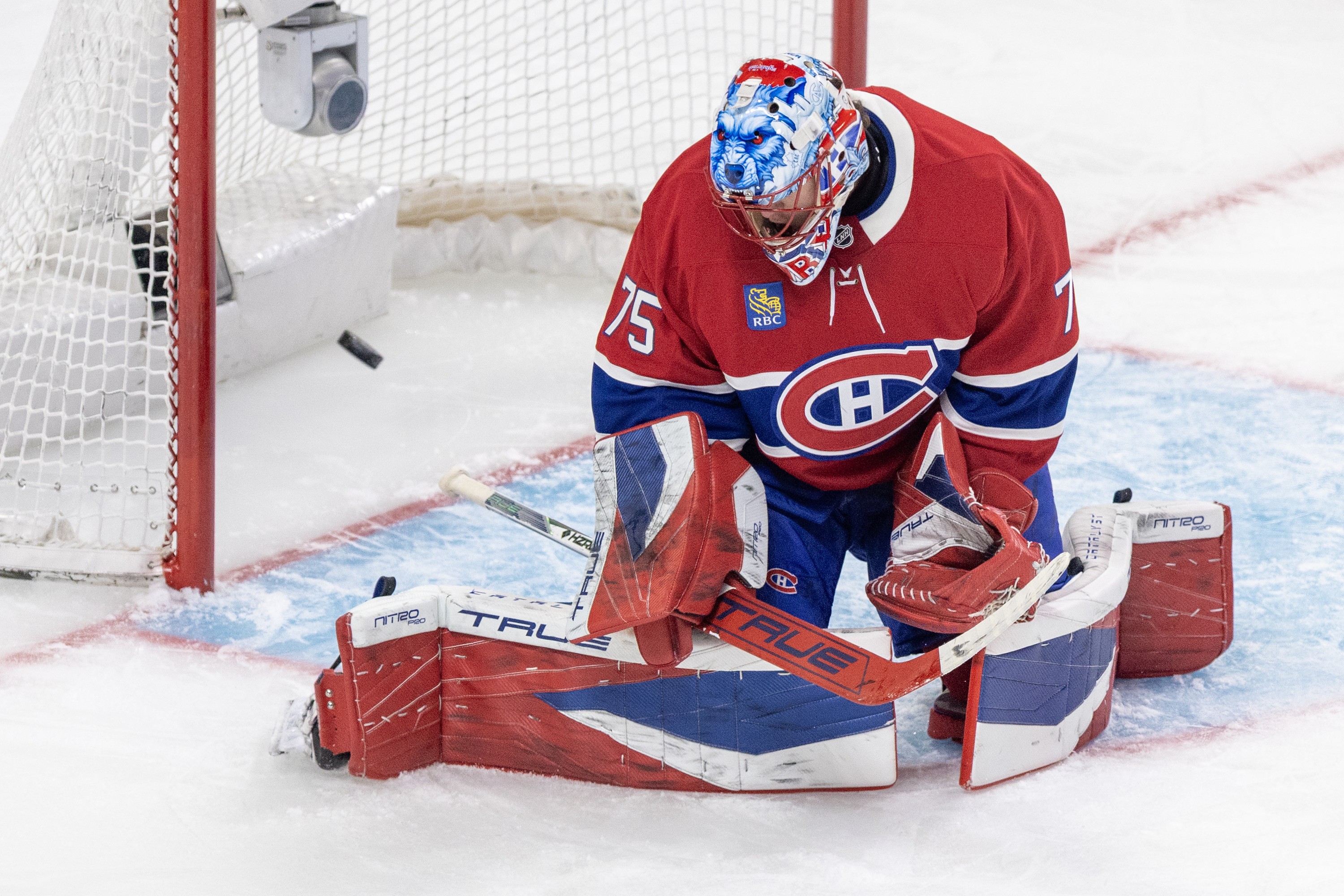 Canadiens goalie Jakub Dobes is on his knees as puck tickles the twine behind him.