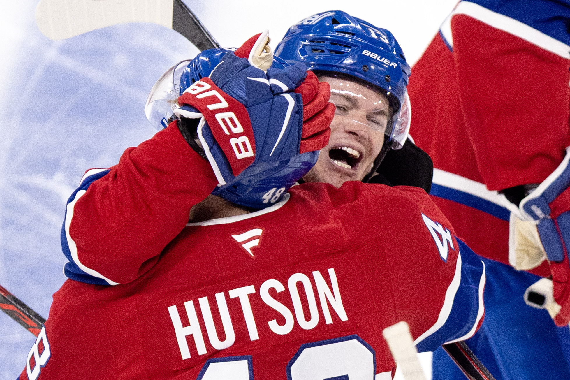 Canadiens' Lane Hutson is hugged by Cole Caufield after scoring the winning goal.