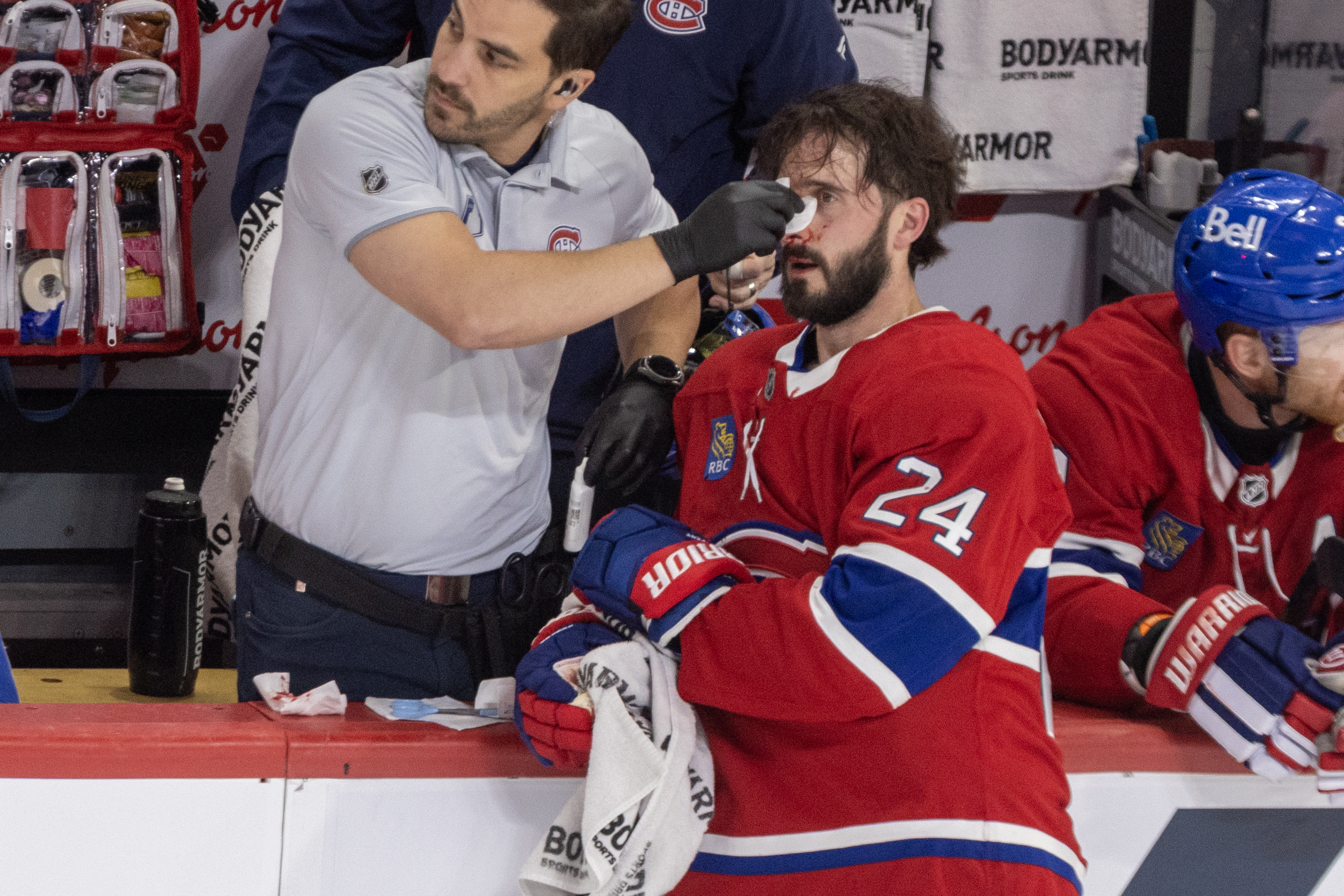 Canadiens' Phillip Danault gets medical attention for a cut on his nose.