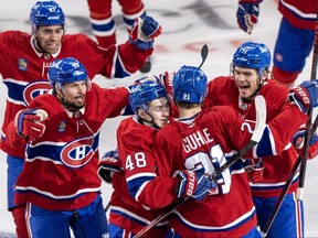 Canadiens players celebrate overtime goal