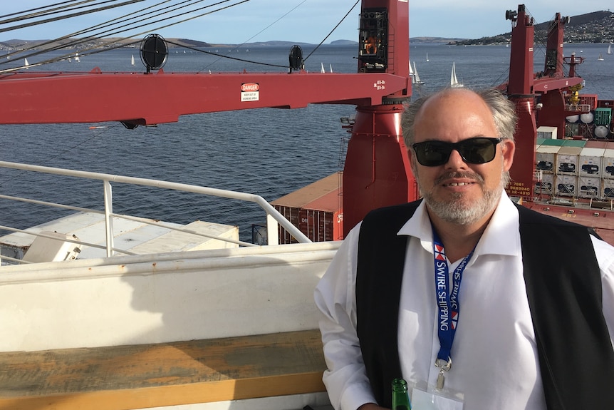 a man stands on a large container vessel