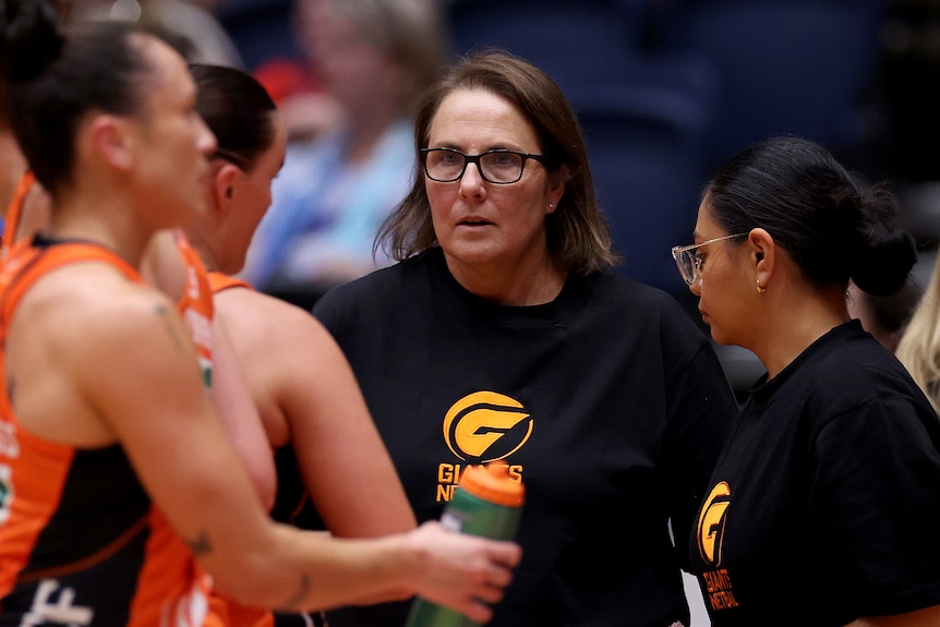 A coach looks sternly at her players