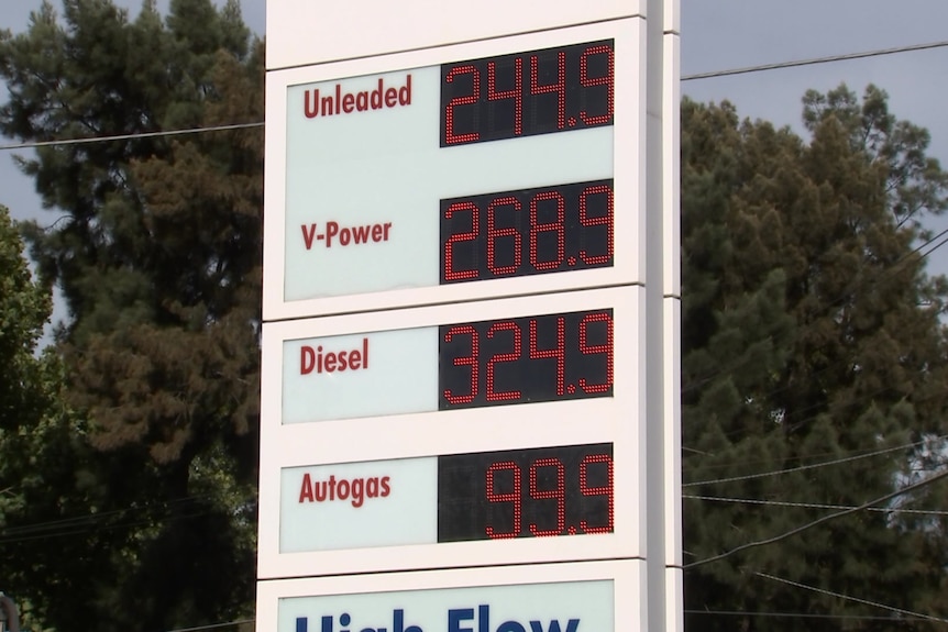 An LED price board displays the cost of fuel outside a petrol station.